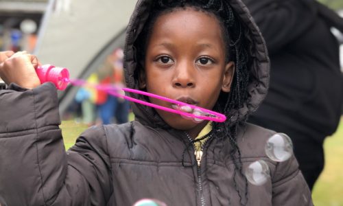 girl blowing bubbles