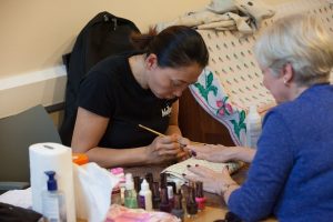 woman having her nails painted