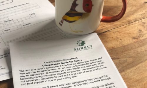 carers assessment document with cup