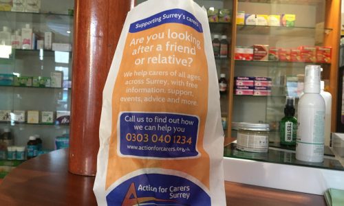Pharmacy bag with ACS ad on counter