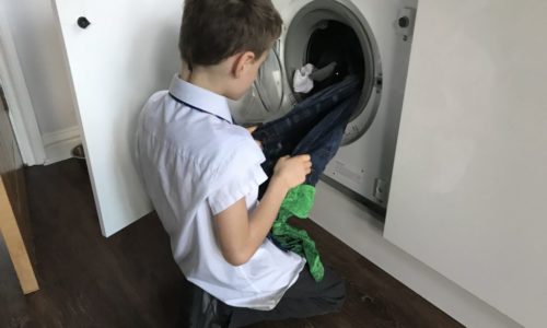 child emptying washing machine