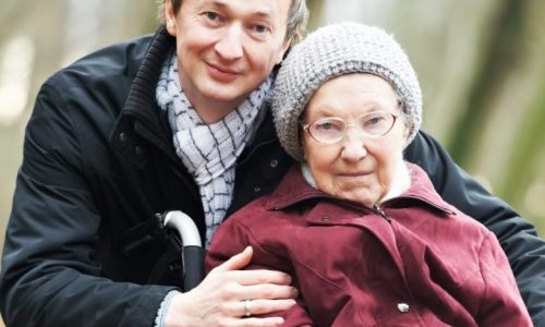 man with older lady in wheelchair