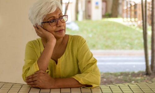 older woman sitting thinking