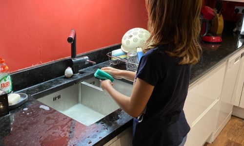 child doing dishes