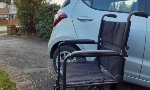 wheelchair next to car