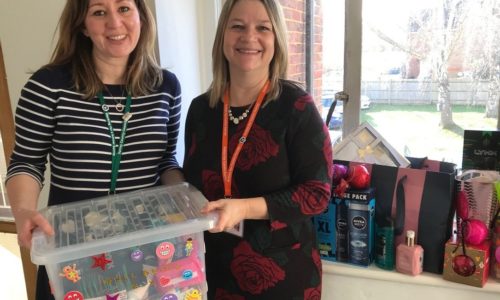 two women with box of donations