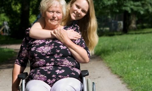 Young woman with older lady using wheelchair