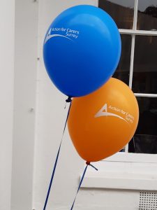 blue ballon and orange ballon with Action for Carers design