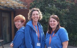 three women in blue Surrey Young Carers uniform