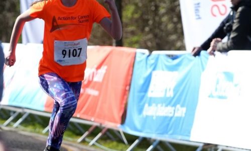 girl running in funrun in orange charity tshirt