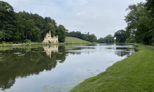 white folly in landscape across river