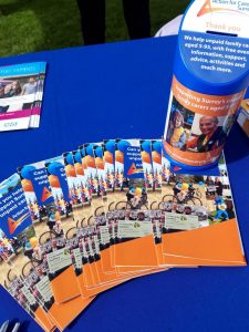 Charity collecting tin on table with leaflets