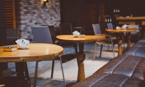 empty cafe tables with grey walls