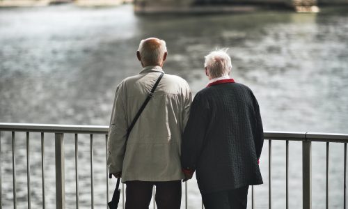 older-couple-hand-hold-riverside