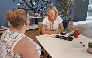 Volunteer chatting with carer