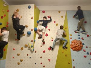 Young carers up climbing wall enjoying time with other young carers