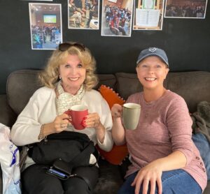 two ladies drinking coffee at Carers at Action for carers hub in Guildford