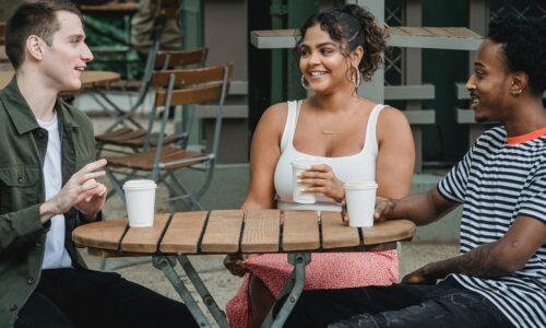 young adult carers sitting at table chatting in Surrey