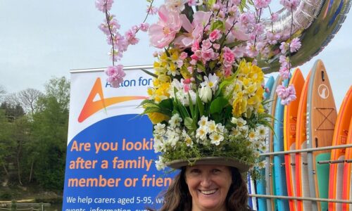 Supporter in flower hat while running and raisng money
