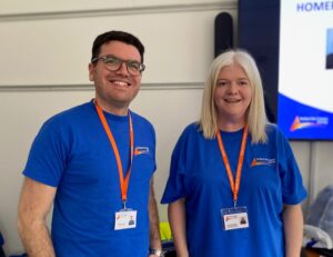ACS Benefits team Drew and Amanda wearing ACS blue tshirts
