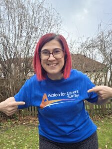 Carer Vicky practising for the Surrey Half Marathon smiling outside in her ACS t-shirt